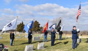 Volunteers holding flags at the Wreaths Across America Ceremony