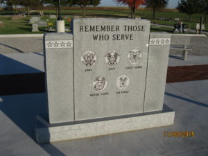 Veterans monument inscribed with the emblem of each branch of the military.