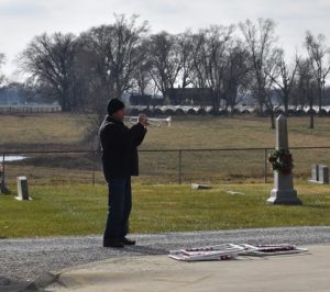 Volunteer playing an instrument at the Wreaths Across America Ceremony