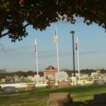 Veterans monument flanked by flags.